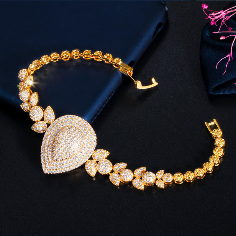 royal dewdrop radiance – 18k gold plated cz leaf charm statement bracelet royal dewdrop radiance – 18k gold plated cz leaf charm statement bracelet