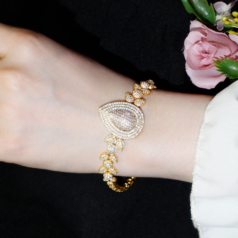 royal dewdrop radiance – 18k gold plated cz leaf charm statement bracelet royal dewdrop radiance – 18k gold plated cz leaf charm statement bracelet