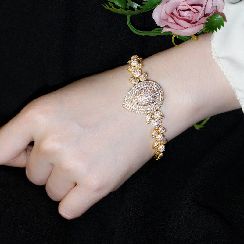 royal dewdrop radiance – 18k gold plated cz leaf charm statement bracelet royal dewdrop radiance – 18k gold plated cz leaf charm statement bracelet